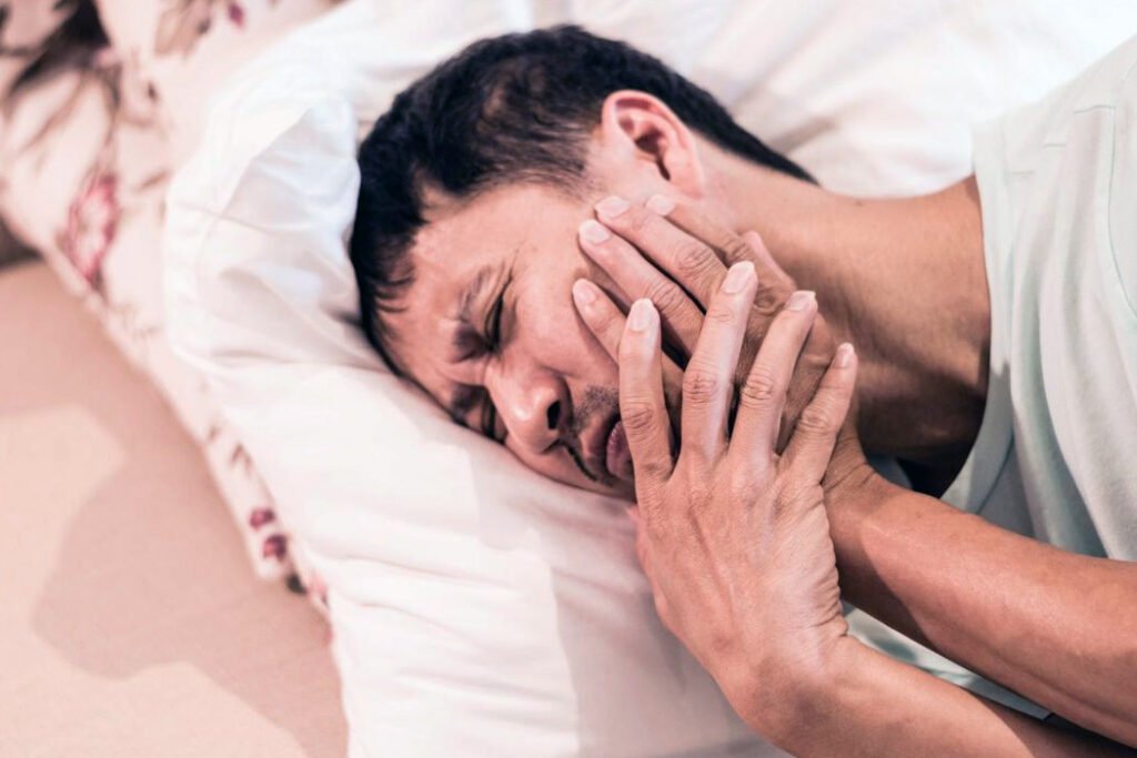 Man Experiencing TMJ Pain & Discomfort